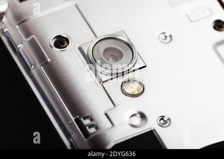Smartphone taken apart, camera lens, macro, extreme closeup. Mobile phone teardown, disassembly tech service repairs abstract concept, nobody Stock Photo