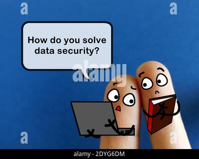 Two fingers are decorated as two person. They are discussing about how to solve data security. Stock Photo