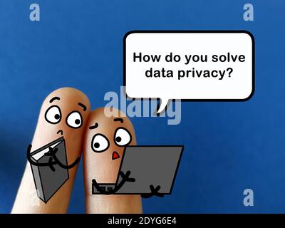 Two fingers are decorated as two person. They are discussing about how to solve data privacy problems. Stock Photo