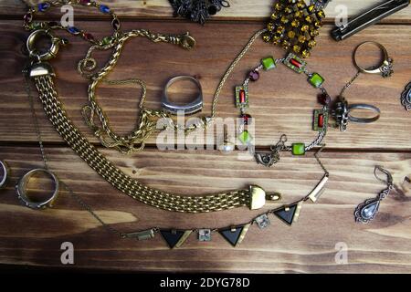 Top down view on isolated group gold and silver precious jewellery pieces on wood table Stock Photo
