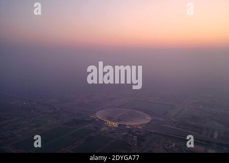 (201226) -- XIONGAN NEW AREA, Dec. 26, 2020 (Xinhua) -- Aerial photo taken on Dec. 26, 2020 shows the Xiongan Railway Station, which is along the railway linking Beijing and Xiongan New Area, in Xiongan, north China's Hebei Province. The intercity railway section linking Beijing Daxing International Airport with Xiongan New Area will be officially put into operation on Sunday. Passengers can take high-speed trains from Beijing West Railway Station directly to Xiongan New Area with the shortest commuting time at 50 minutes. The travel time between the airport and Xiongan New Area will be short Stock Photo