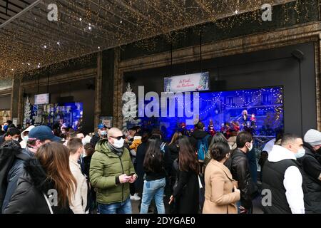 Paris, France. December 20. 2020. Christmas showcase of the famous fashion and luxury store Printemps. People looking at the decorations. Stock Photo