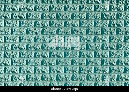 Textured turquoise stone wall forms geometric abstract background pattern Stock Photo