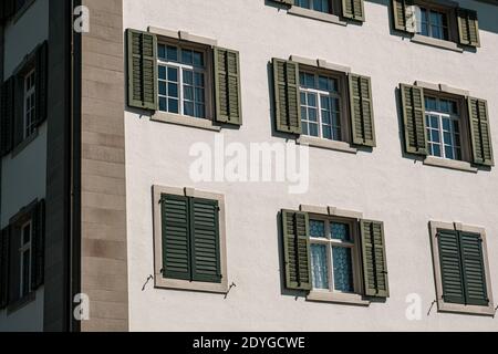 rustic windows with green shutters Switzerland. Stock Photo