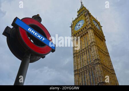 BREXIT conceptual image in London with Big Ben and Brexit word written over an underground street sign. Stock Photo