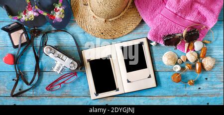 enjoying photography during summer holidays, camera, photo album with empty frames and vacation items,flat lay Stock Photo