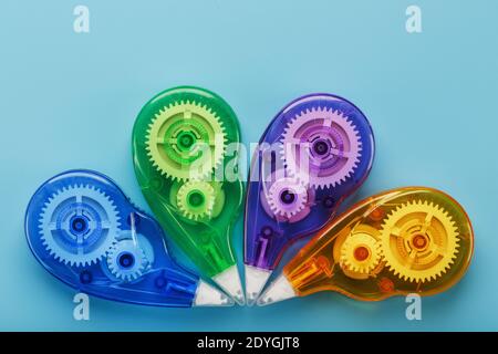 Stationery correction tapes are Multicolored on a blue background. Free space. The view from the top. Blue, green, yellow, lilac Stock Photo