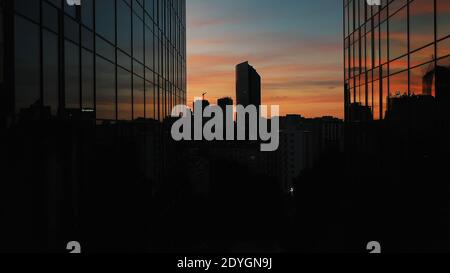 Breathtaking red sunset over the Warsaw reflecting on the glass windows on the skyscrapers. Silhouettes of the buildings in the distance. High quality photo Stock Photo