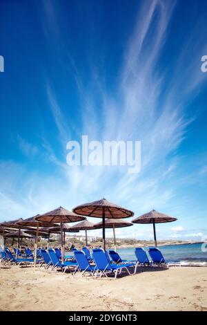 Umbrellas and chairs at the ready on Kalathas beach near Chania, Crete. Stock Photo