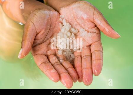 Woman Holding Salt Crystals of the Dead Sea. Stock Photo