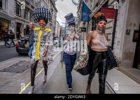 London, UK. 26th December 2020. Models take part in a colourful Boxing Day flashmob fashion show taking advantage of the near empty streets of the west end for designer Pierre Garroudi. Credit: Guy Corbishley / Alamy Live News