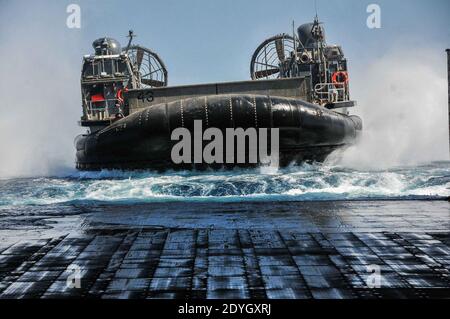 Landing Craft Air Cushion (LCAC) enters the well deck of the USS New Orleans (LPD-18). Stock Photo