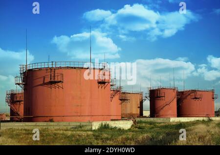 organized storage tanks of petroleum products on the background of the cloudy sky Stock Photo