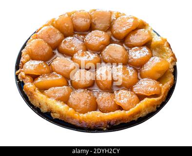 home-made caramelised apple pie Tarte Tatin on plate cut out on white background Stock Photo