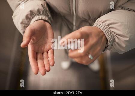 Close-up of woman applying antiseptic on her hands Stock Photo