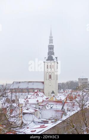 Old town of Tallinn in Estonia. Vertical photo of St. Nicholas Church, Niguliste facade and roofs of old town at winter time Stock Photo