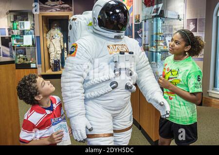 Huntsville Alabama,Visitors Center centre,Black girl boy brother sister siblings looking astronaut space suit, Stock Photo