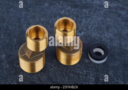 Eccentric connectors from brass for wall-mounted water faucet for installation, close-up, shallow depth of field Stock Photo