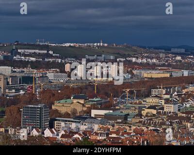 Aerial panorama view of Stuttgart downtown with discolored trees of park area Schlossgarten and construction site of main station development project. Stock Photo