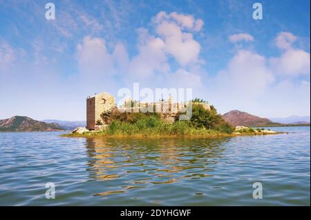 View of Lake Skadar - the largest lake in the Balkans - and the ruined fortress of Grmozur on a small island. Montenegro Stock Photo