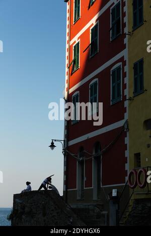 Italy Cinque Terre Silhouettes of several people practicing yoga in the morning.in Riomaggiore Stock Photo