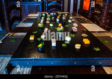 Typical Japanese Dinner by Atsuko Kato. Table decorated with autumnal dishes at Restaurant Rakan. Guests describe a visit to Atsuko Kato as an unforgettable experience with high artistic standards and a deep connection to Japanese tradition Stock Photo