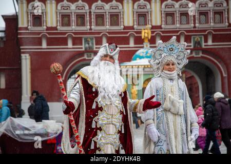 Moscow, Russia. 27th of December, 2012 People dressed as Father Frost (Russian Santa Claus) and Snegurochka (Snow Maiden) take part in New Year celebration in central Moscow on Manege square during winter festival, Russia Stock Photo