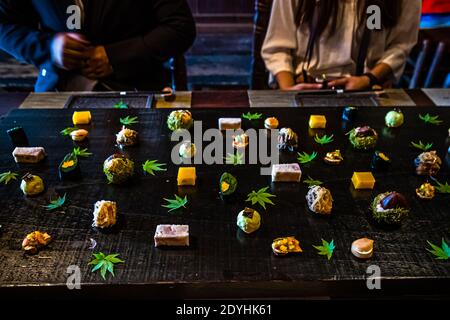 Table decorated with autumnal dishes at Restaurant Rakan. Guests describe a visit to Atsuko Kato as an unforgettable experience with high artistic standards and a deep connection to Japanese tradition. Typical Japanese Dinner by Atsuko Kato Stock Photo