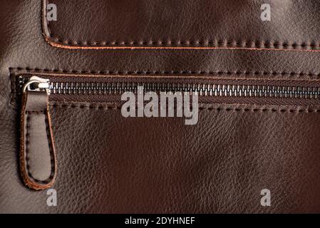 Zipper on brown leather product. Keychain puller. Close up. Stock Photo