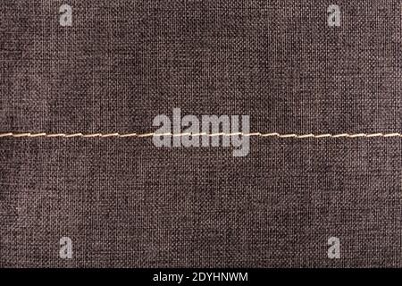 Textile surface with stitching. Textured gray background. Stock Photo