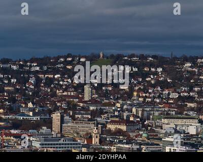 Beautiful aerial panoramic view of densely populated city center of Stuttgart located in valley (so-called 'Kessel') with historic tower Bismarckturm. Stock Photo