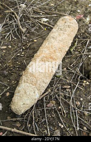 A farmer plowed up a World War 1 artillery shell during spring plowing and laid it on the side of the field for disposal, near Vaux-sur-Somme, Stock Photo