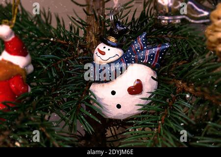 Snowman ornament hanging on Christmas tree. Stock Photo