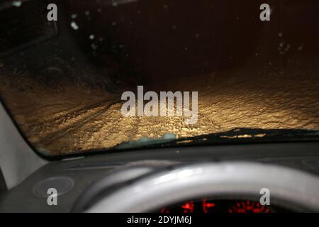 Road covered in snow viewed from inside car. Stock Photo