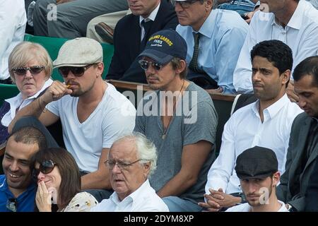 Leonardo DiCaprio smokes an electronic cigarette and PSG's President Nasser Al-Khelaïfi attending a quarter final match at the French Tennis Open at Roland-Garros arena in Paris, France on June 5, 2013. Photo