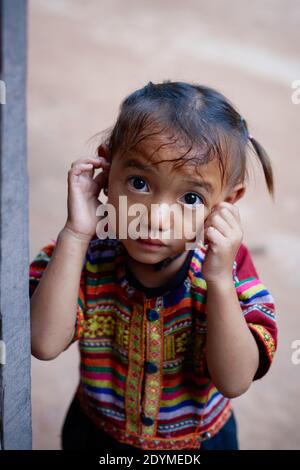 Luang Namtha, Laos - November 2019: Laotian little girl from Khmu   ethnic group in local village Stock Photo