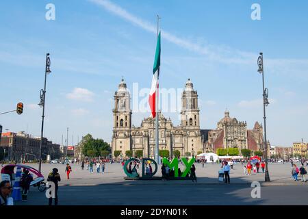 Mexico National Flag on Zocalo Constitution Square and Metropolitan Cathedral in the morning, Mexico City CDMX, Mexico. Stock Photo