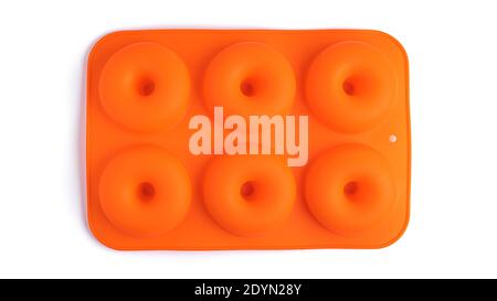 Orange silicone donut baking dish on a white background. High quality photo Stock Photo