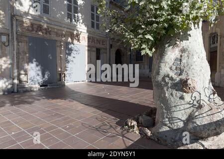 Marseille, France, Early Morning sunlight casts shadows on a closed cafe bar in historic the Le Panier District. Stock Photo