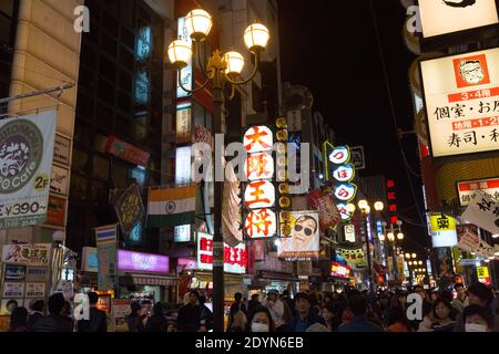 Illuminated signs and billboards over crowded  Dotombori District at night. Stock Photo