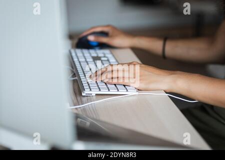 hands grasping keyboard and mouse Stock Photo