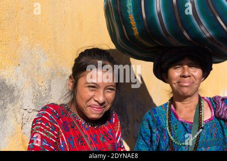 Antigua, Guatemala Indigenous girl laughing, with mother Stock Photo