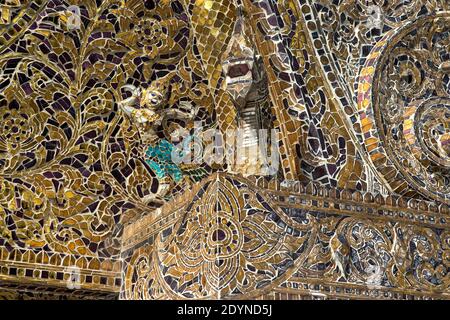 Elaborate glass mosaic decorations, Standing Buddha Chapel, Wat Xieng Thong, Luang Prabang, Laos Stock Photo