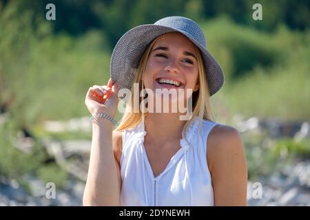 Portrait young blonde woman with sun hat in summer, Bavaria, Germany Stock Photo