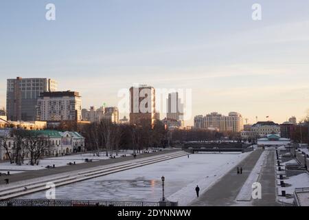 YEKATERINBURG, RUSSIA, embankment of the Iset river in winter. Frozen pond in the city center. Ice on the river in the city. Winter in Russia. Stock Photo