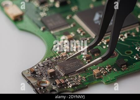 Microcircuit macro close up green color. Concept for technology, repair of computers, smartphones and electronics. Stock Photo