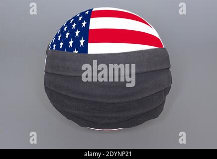 World earth globe with USA flag and black medical protective mask to protect against coronavirus. Stock Photo