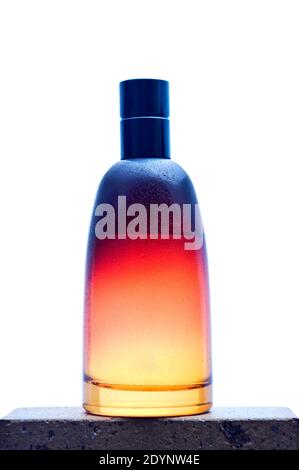 Orange glass bottle for perfume with diffuser on white background. Stock Photo