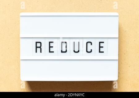 Lightbox with word reduce on wood background Stock Photo