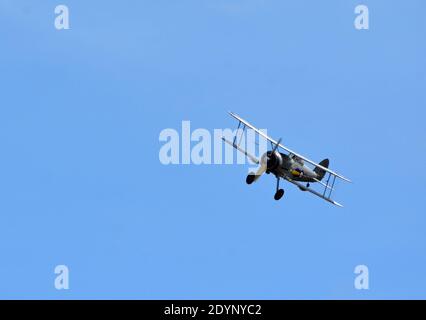 Vintage Gloster Gladiator aircraft in flight with blue sky background Stock Photo